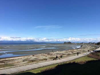 Scenic view of beach against blue sky