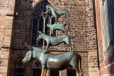 Low angle view of horse statue against building