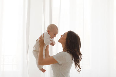 Woman playing with infant child