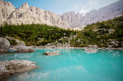 Scenic view of calm lake by sorapiss mountains against sky