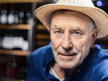 Close-up portrait of senior man wearing hat