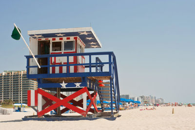 Lifeguard hut on beach against clear sky