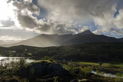 Scenic view of agricultural landscape against dramatic sky