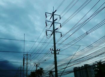 Low angle view of electricity pylon against sky