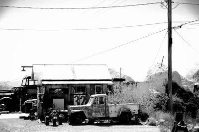 Cars on street against sky