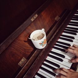 High angle view of person playing piano