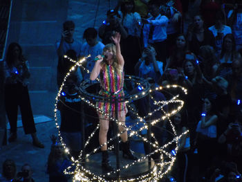 People enjoying illuminated music concert at night