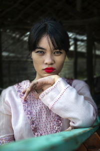 Portrait of a young woman sitting outdoors