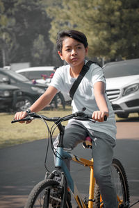 Boy riding bicycle in around town