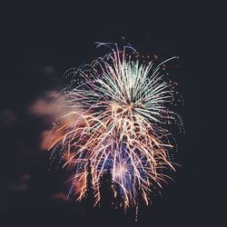 Low angle view of firework display at night