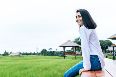 Young woman sitting on field