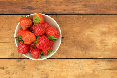 High angle view of strawberries in bowl on table