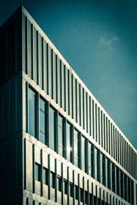 Low angle view of modern building against clear blue sky