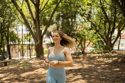 Woman running and jogging at a park outdoors. athlete female person during workout. healthy 