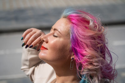 Portrait of young woman with pink hair