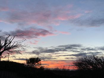 Scenic view of silhouette trees against sky during sunset