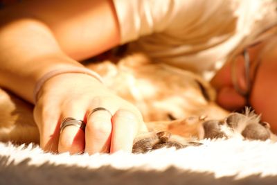 Midsection of person lying down on bed