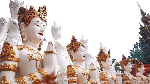 Low angle view of statue against temple against clear sky