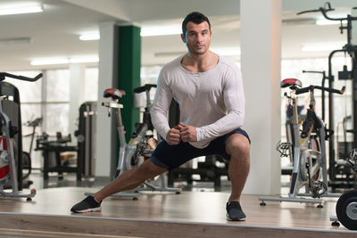 Muscular man exercising in gym