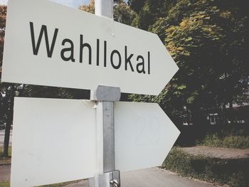 Close-up of road sign against trees