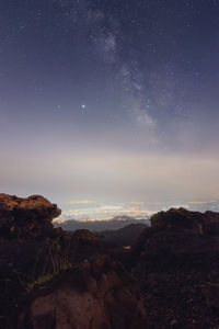 Scenic view of rocks against sky at night