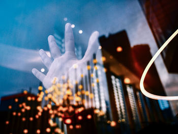 Low angle view of woman standing against sky