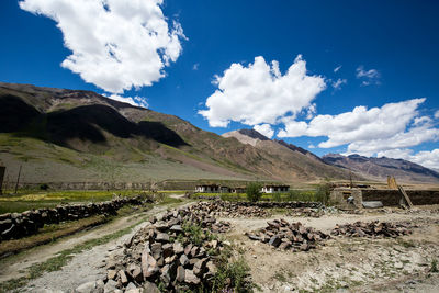 Scenic view of landscape and mountains against blue sky