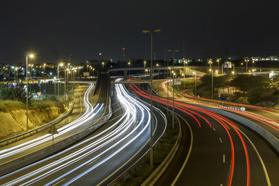 Long exposure shot of highway at night, with cars driving in the road