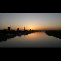 Scenic view of river at sunset