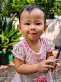 Portrait of cute girl holding outdoors