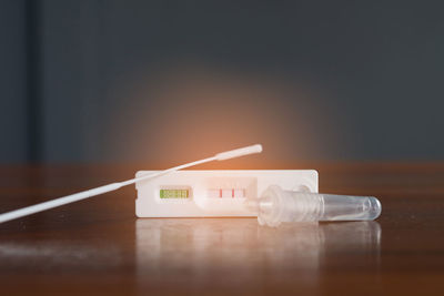 Close-up of syringe on table