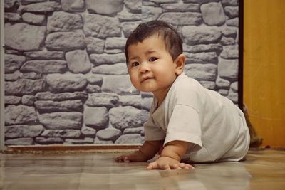 Portrait of cute boy girl sitting on floor at home