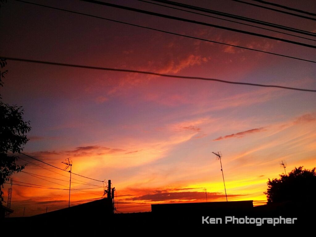 sunset, power line, silhouette, electricity pylon, orange color, cable, sky, power supply, electricity, connection, low angle view, building exterior, built structure, architecture, cloud - sky, power cable, fuel and power generation, technology, house, no people