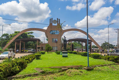 Park by buildings against sky in city