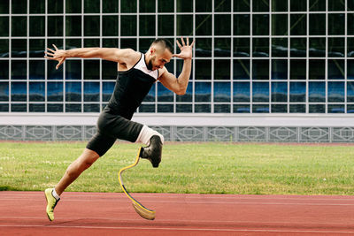 Full length of man jumping on grass