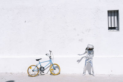 Side view of bicycle against white wall