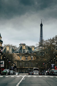 Buildings in city against cloudy sky