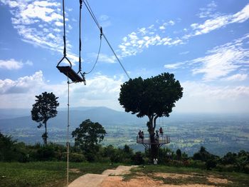 Trees on field against sky