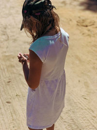 Rear view of woman standing on beach