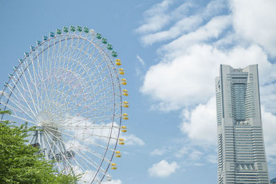 Low angle view of ferris wheel against sky