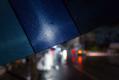 Close-up of wet umbrella at night