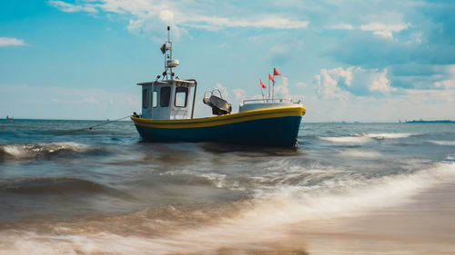 Boat in sea against sky