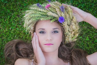 Close-up portrait of woman in grass