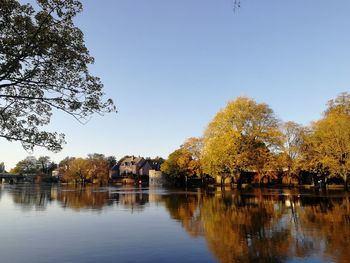 Scenic view of lake against clear sky during autumn