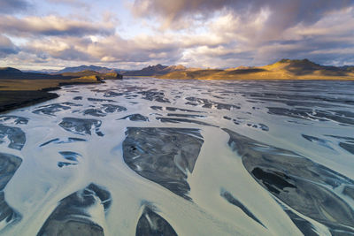 Aerial view of sea against sky during sunset