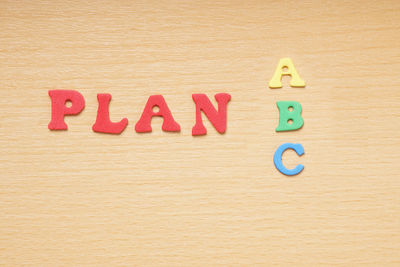 High angle view of colorful plan text on wooden table