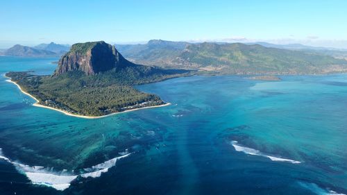 Panoramic view of sea and mountains against sky