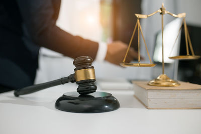 Close-up of hand holding wineglass on table