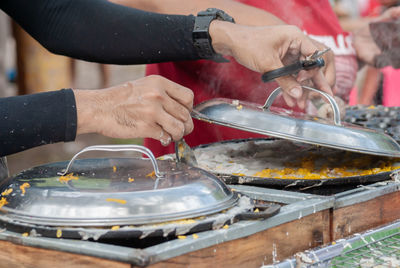 Cropped hand of man preparing food