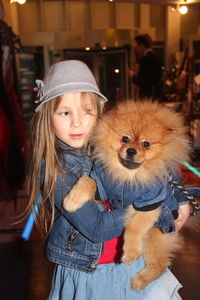 Cute girl with carrying dog